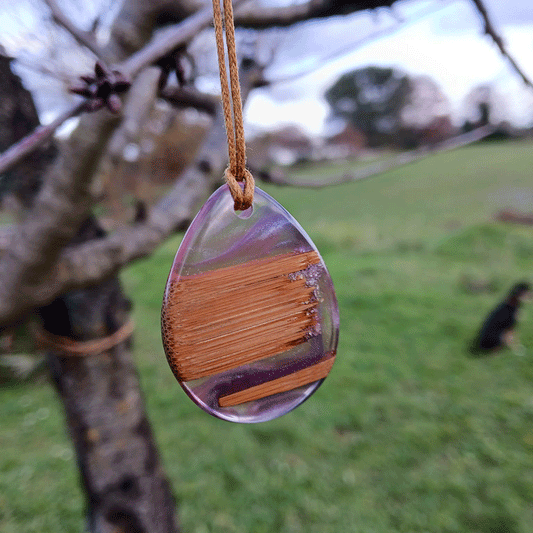Driftwood with transparent purple and pink resin