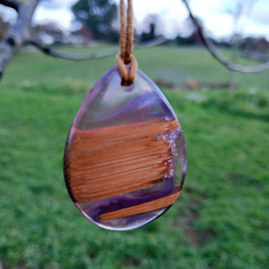 Driftwood with transparent purple and pink resin