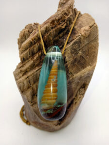 Driftwood with light blue resin and spiral shell