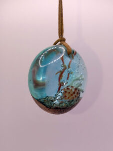 Driftwood with light blue resin, coral and shell