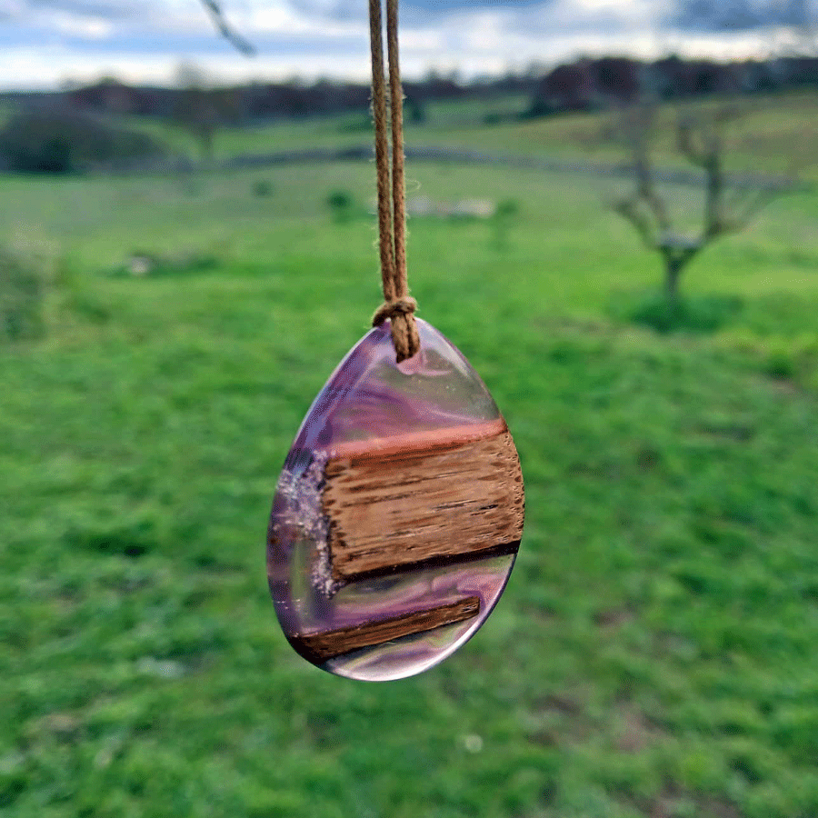 Driftwood with transparent purple and pink resin
