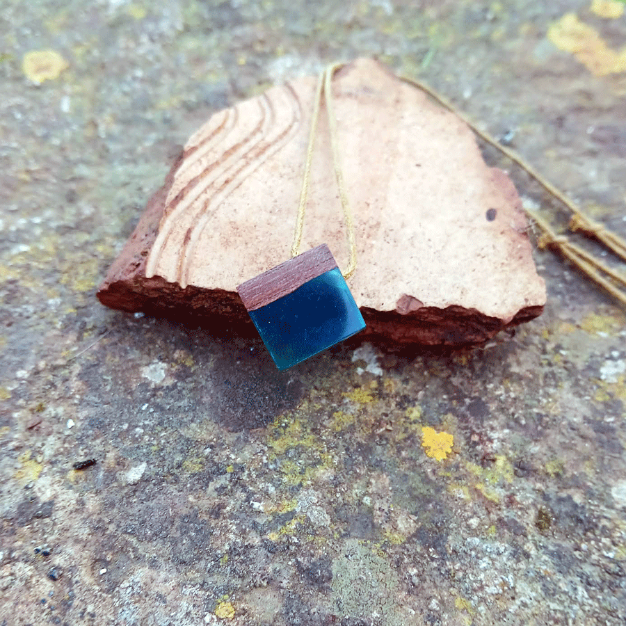 Driftwood with transparent teal resin