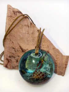 Driftwood with light blue resin, coral and shell