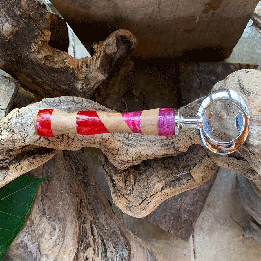 Driftwood and pink and red resin bottle opener