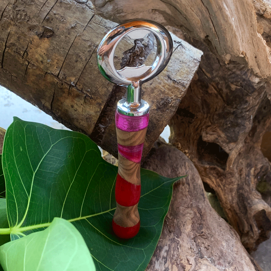 Driftwood and pink and red resin bottle opener